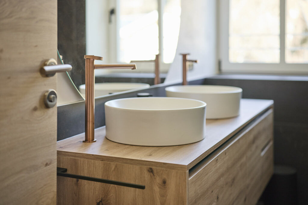 Modernes Badezimmer mit Holzwaschtisch und zwei Aufsatzwaschbecken